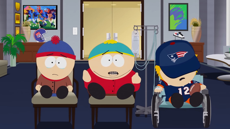 South Park, Stan, Cartman, and Kenny sitting in chairs, Kenny's face obscured by hat