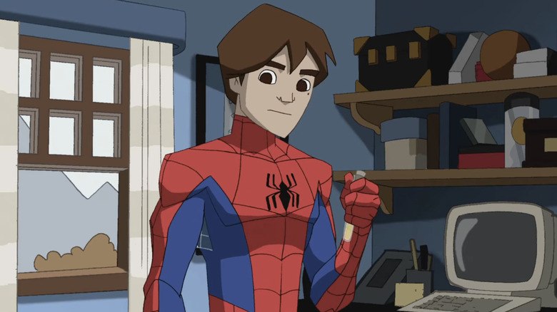 Spider-Man wearing a red and blue costume, with a small black spider logo on his chest. He isn't wearing a mask and he has medium-length brown hair. He's holding a test tube in his left hand while standing in his bedroom, there is an old computer on the desk behind him.
