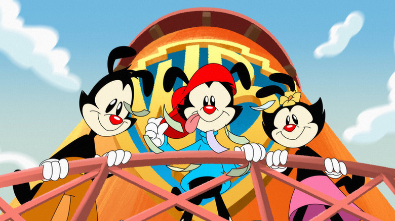 Yakko, Wakko, and Dot looking down from the Warner Bros. water tower in Animaniacs (1995)