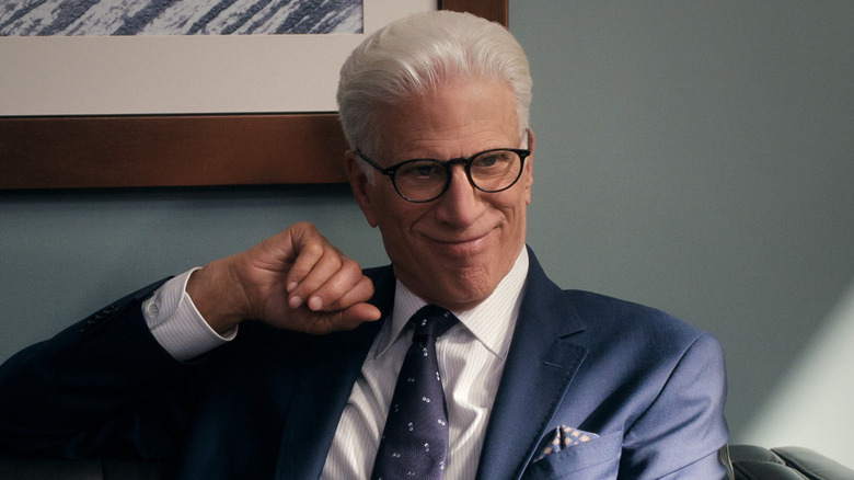 Charles smiling excitedly while sitting on a couch