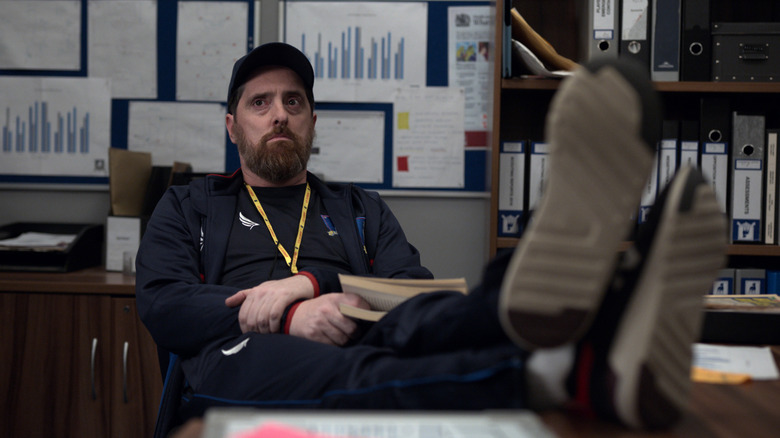 Coach Beard looking at someone in the Richmond coaches office with his feet on his desk