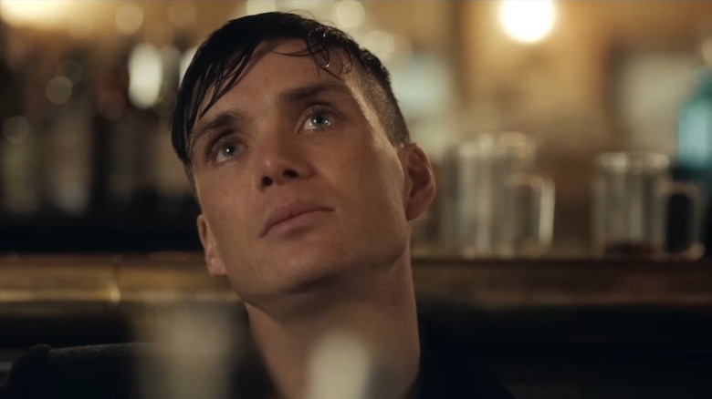 Cillian Murphy as Tommy Shelby with wet hair looking up in Peaky Blinders