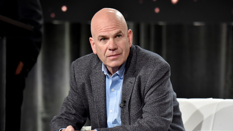 David Simon speaks on stage in 2020