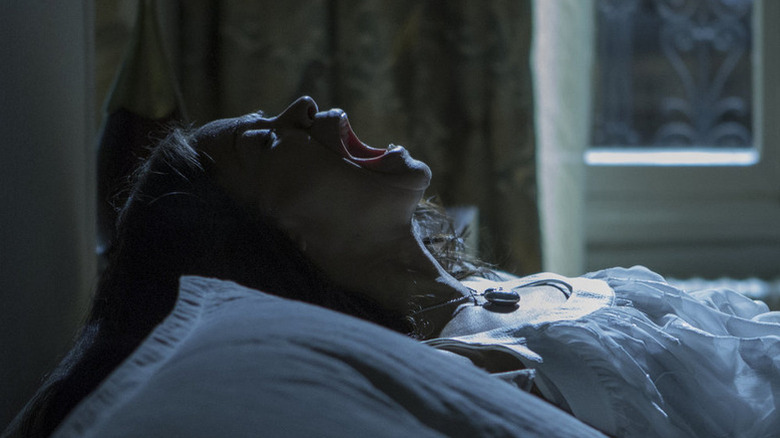 Rosemary lying on a bed and screaming