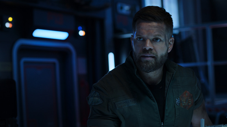 Amos in a dark, futuristic room in "The Expanse" (2015)