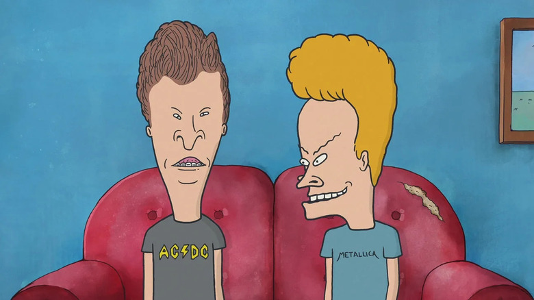 Beavis wears his Metallica t-shirt while staring at Butt-Head in his AC-DC shirt as they sit on a red couch on Beavis and Butt-Head