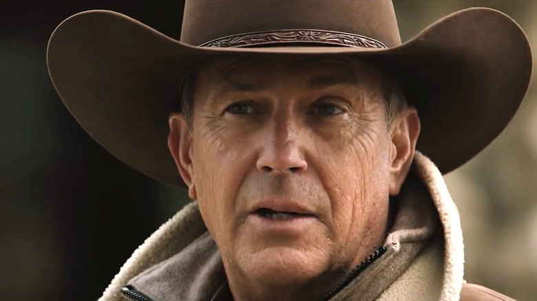 Kevin Costner as John Dutton wearing a fleece jacket with a brown cowboy hat.