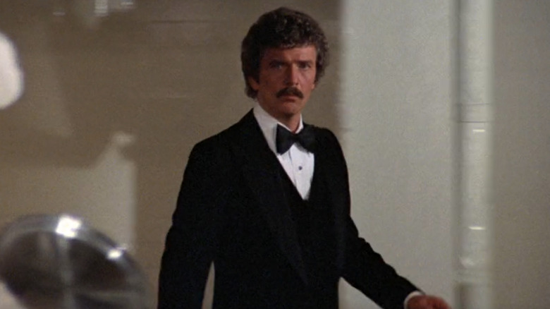 Glenn Staley in tuxedo walking through kitchen