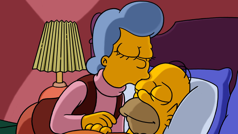 Mona tucking Homer in bed in The Simpsons