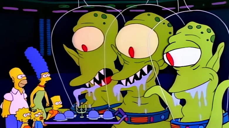 The Rigellians Kang, Kodos and Serak the Preparer present the Simpsons with a feast aboard their spaceship.