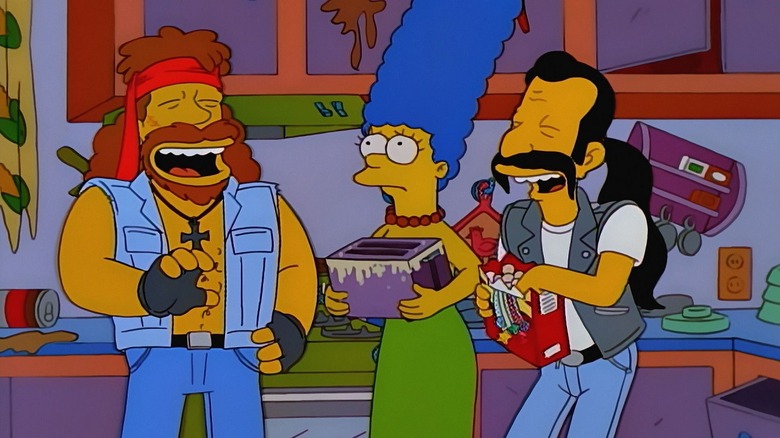 Marge Simpson holding a damaged toaster in the middle of a damaged kitchen while two members of motorbike gang laugh
