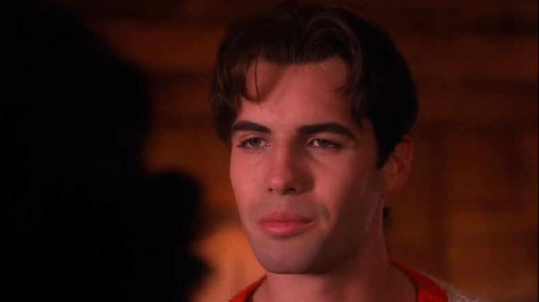 John Justice Wheeler wearing a white and orange sweater looking at a woman offscreen in "Twin Peaks."