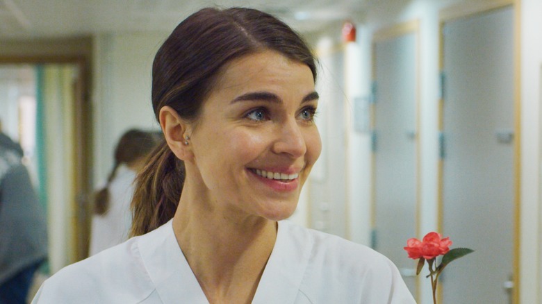 Johanne smiling in white nurse uniform in a hospital in "Home for Christmas."