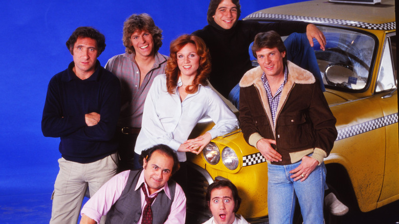 The cast of "Taxi" smiling at camera.