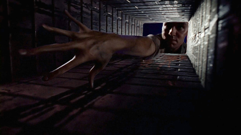 Eugene Tooms reaching his hand deep inside a chimney