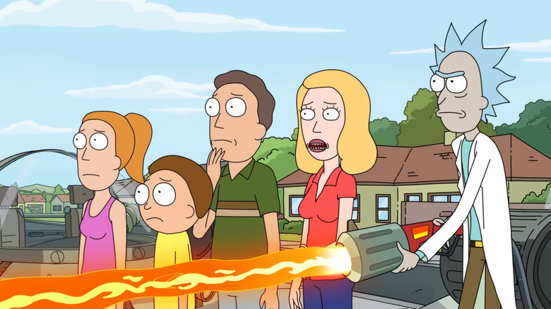 The Smith family standing outside while Rick burns down another decoy family's house