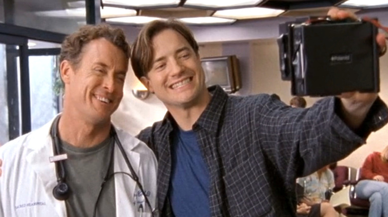 Dr. Cox and Ben taking a photo together in Scrubs