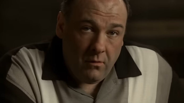 Tony Soprano in a striped shirt, looking up