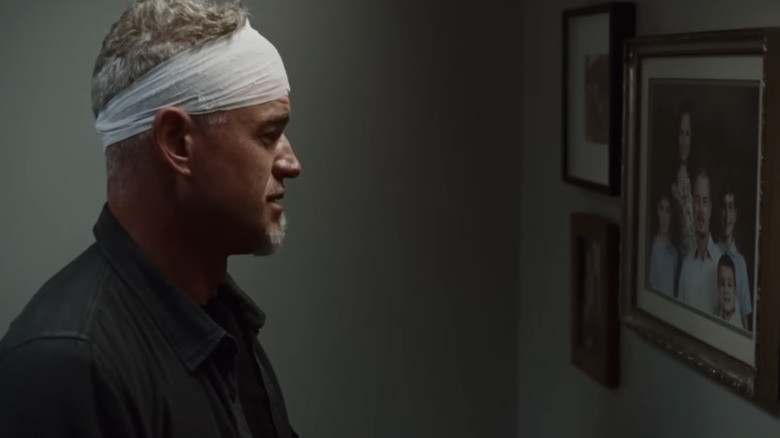 Eric Dane as Cal Jacobs looking at a family photograph in "Euphoria"