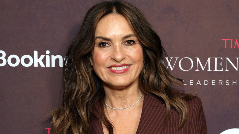 Mariska Hargitay in a brown suit in front of a brown background