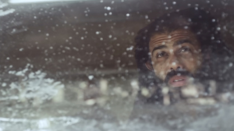 Andre Layton looking out of a snowy window in Snowpiercer