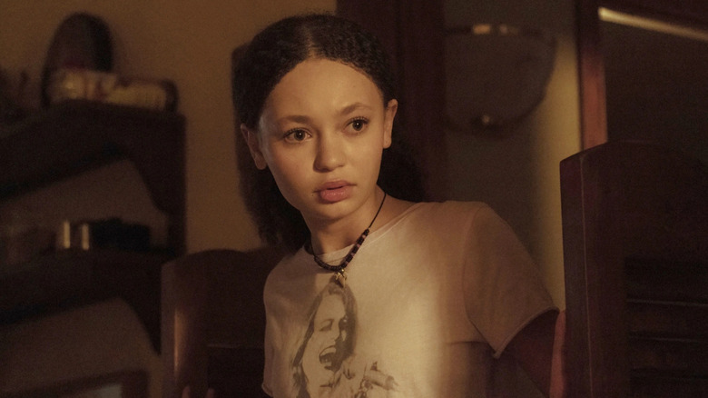 Nico Parker as Sarah, walking through a room in The Last of Us.