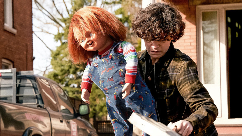 Jake Wheeler (Zackary Arthur) carries a Chucky doll in "Chucky"