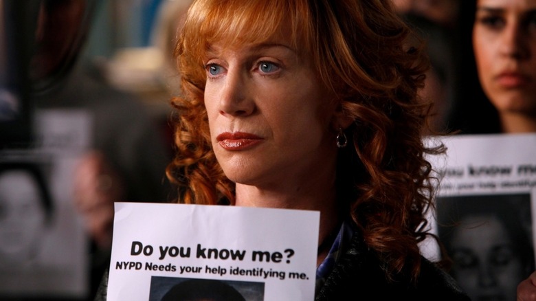 Babs Duffy holding a missing person poster in 'SVU'
