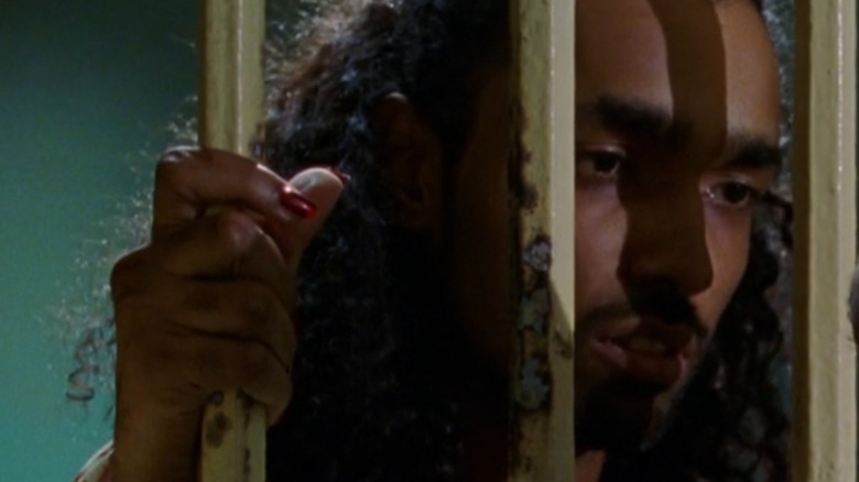 Ortega holding their cell bars in Law & Order: SVU