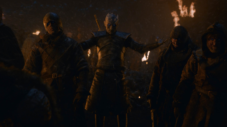 The Night King, poorly lit so you can barely see him, commanding wights during the Battle of Winterfell in Game of Thrones Season 8 (2019)