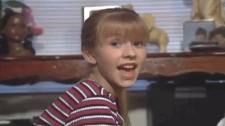Young Christina Aguilera in a living room wearing a striped shirt during a scene from "The All-New Mickey Mouse Club."