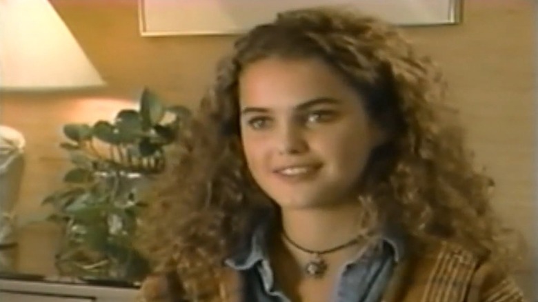 Keri Russell with voluminous curly hair speaking in a scene from "The All-New Mickey Mouse Club."
