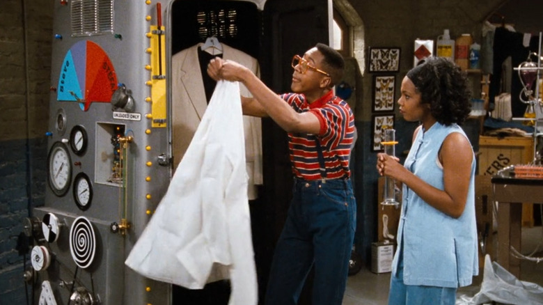 Urkel hangs up his white coat beside the transformation chamber in "Family Matters" (1989)