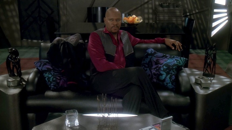 Avery Brooks as Captain Benjamin Sisko, sitting casually in his quarters, looking directly into the camera on Star Trek: Deep Space Nine