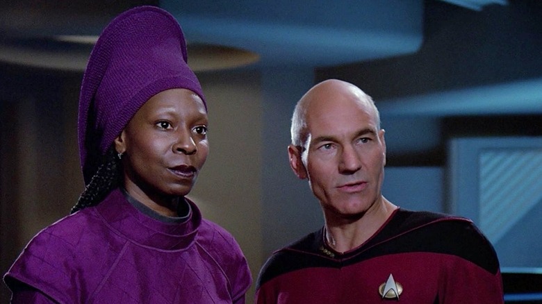 Guinan and Captain Picard standing next to each other aboard the Enterprise in Star Trek: The Next Generation (1987)