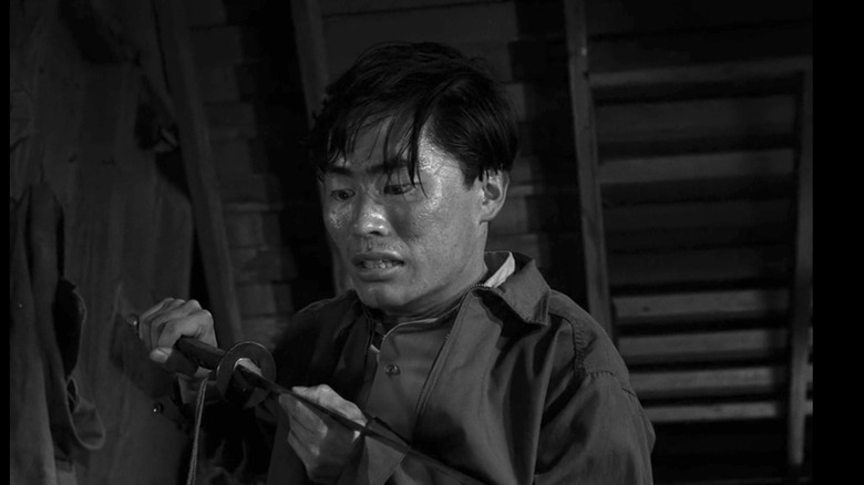 Arthur Takamori looks down at a samurai sword in The Twilight Zone