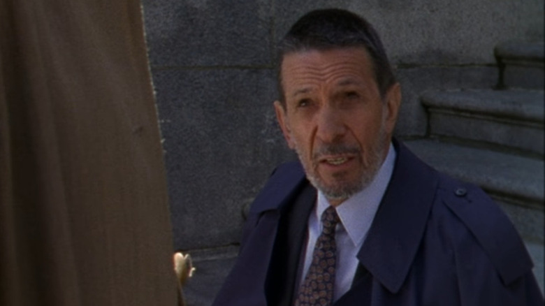 Leonard Nimoy sitting on the steps outside a courthouse in "The Outer Limits" (1995)