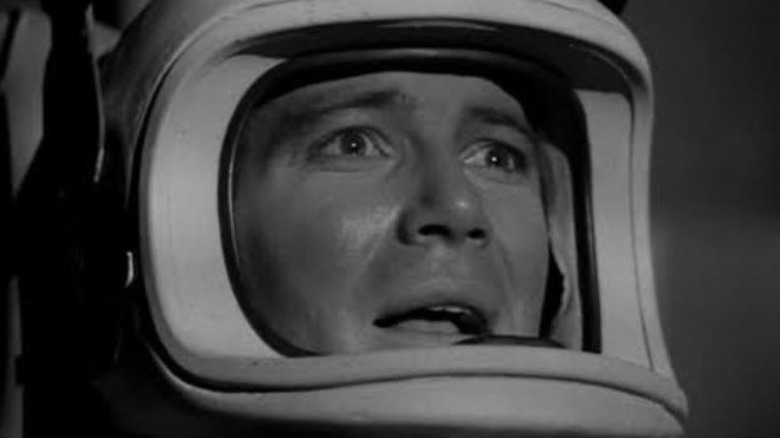 Astronaut Jeff Barton wearing a space suit helmet and looking scared in The Outer Limits