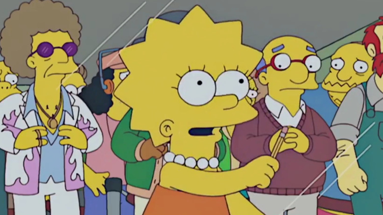 Lisa solves a crossword puzzle while others watch behind her in The Simpsons