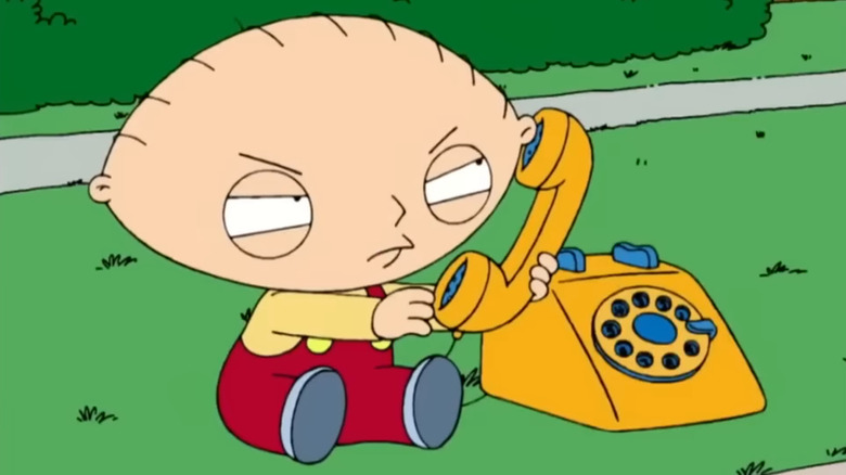 Stewie Griffin plotting on his toy phone in Family Guy