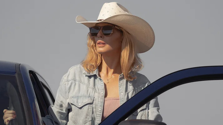 Beth Dutton reaching into a car on Dutton Ranch
