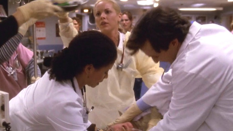 Anna Del Amico, Jeanie Boulet, and John Carter treating medical emergency on "ER"