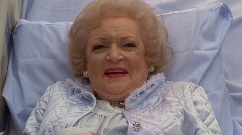 Betty White laughing in a hospital bed in "Ugly Betty"