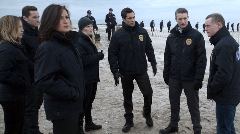 The investigation team of Olivia Benson, Erin Lindsay, and more on a beach in Law & Order: SVU