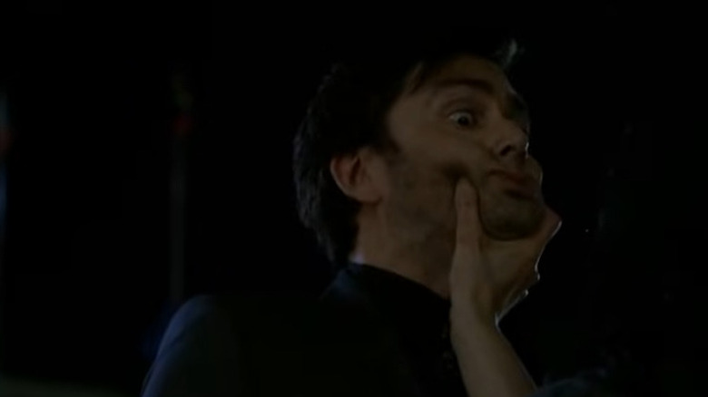 David Tennant as Kilgrave, being held in the air by Jessica Jones' hand in Jessica Jones.