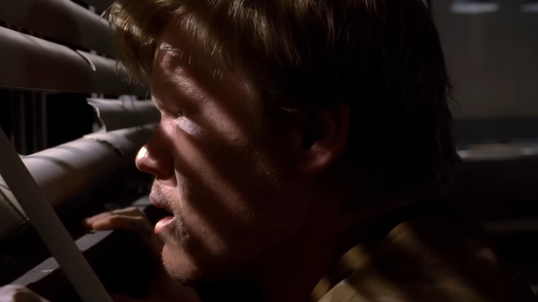 Jesse Plemons as Todd Alquist, looking through blinds in Breaking Bad.