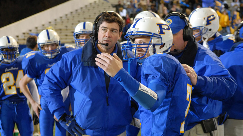 Coach Eric Taylor surrounded by his football players on "Friday Night Lights"