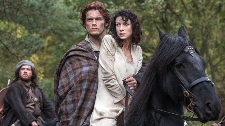 Jamie and Claire on a horse in "Outlander"