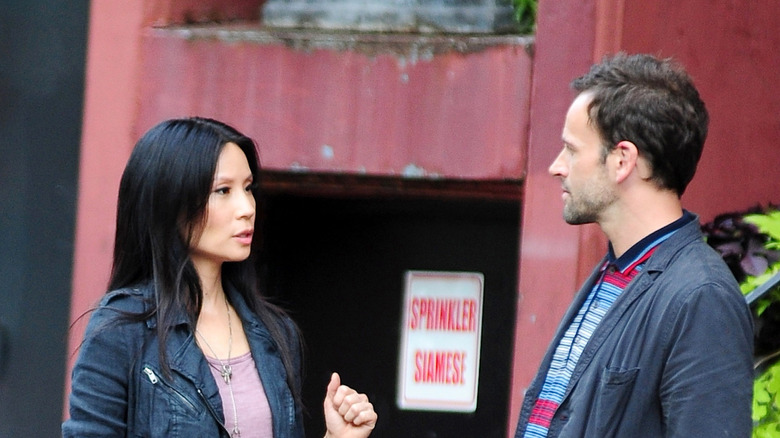 Johnny Lee Miller and Lucy Liu on the set of Elementary