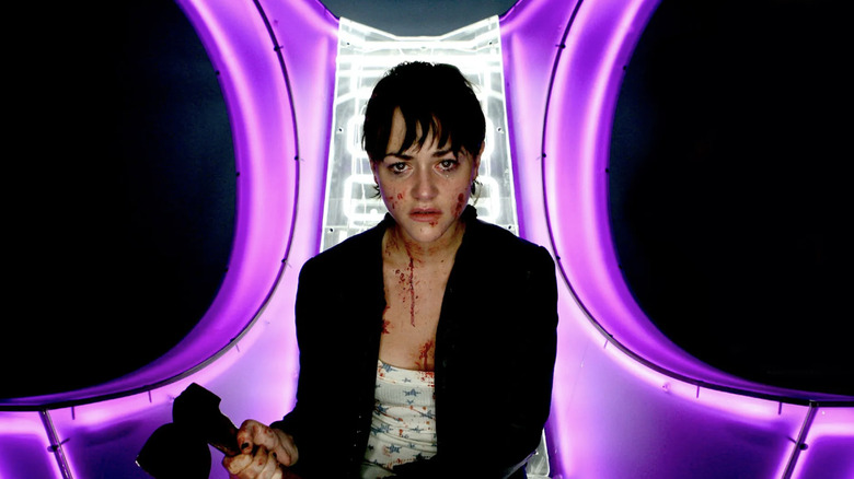 Kelly wields an axe inside the confessional room in "Dead Set" (2008)